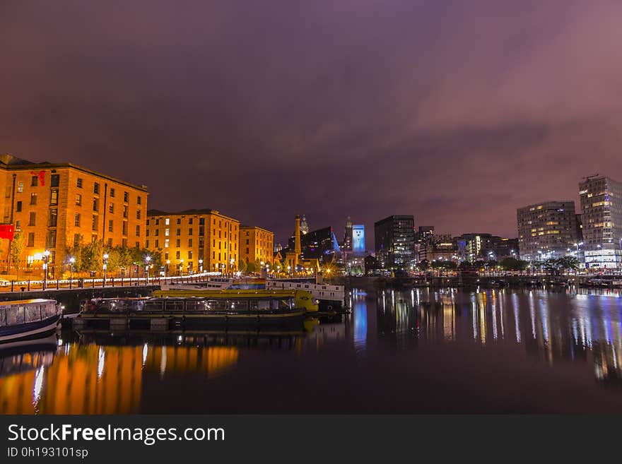 Liverpool, England waterfront docks illuminated and reflecting at night. Liverpool, England waterfront docks illuminated and reflecting at night.