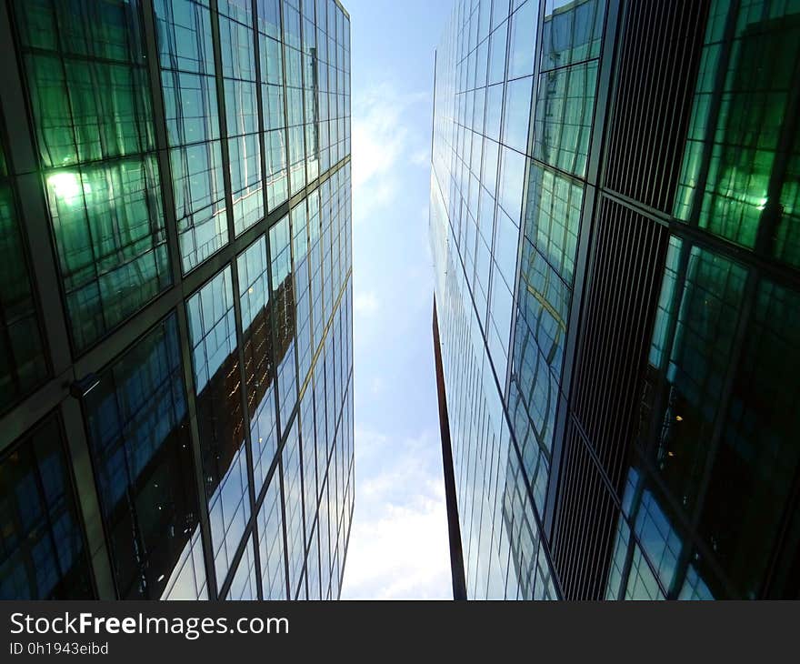 Abstract architectural background created by two similar buildings of steel, glass and concrete built close together and lit from above. Abstract architectural background created by two similar buildings of steel, glass and concrete built close together and lit from above.