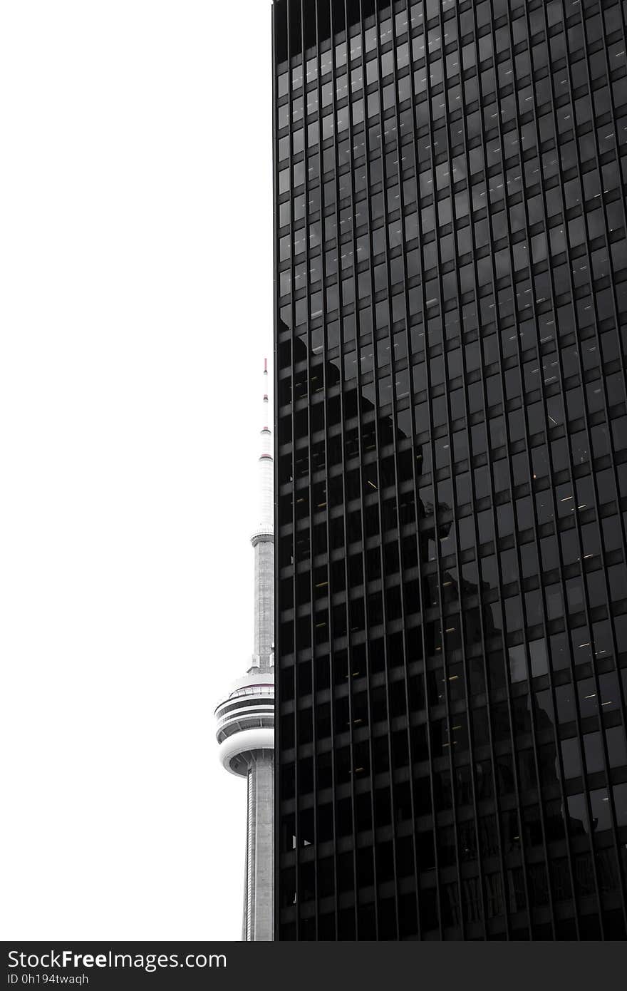 Exterior of modern skyscraper against overcast skies in black and white. Exterior of modern skyscraper against overcast skies in black and white.