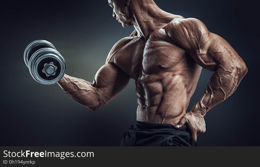 A bodybuilder doing a dumbbell curl. A bodybuilder doing a dumbbell curl.