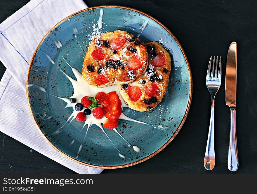 Bread slices with strawberry and blueberry topping and garnish on a plate. Bread slices with strawberry and blueberry topping and garnish on a plate.