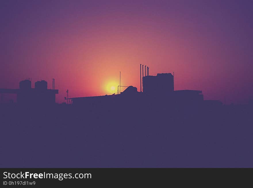 A city view with the sunset behind the buildings. A city view with the sunset behind the buildings.