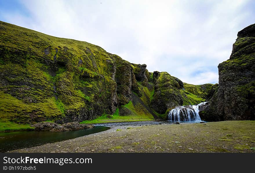 A waterfall and a river passing through a cliff. A waterfall and a river passing through a cliff.