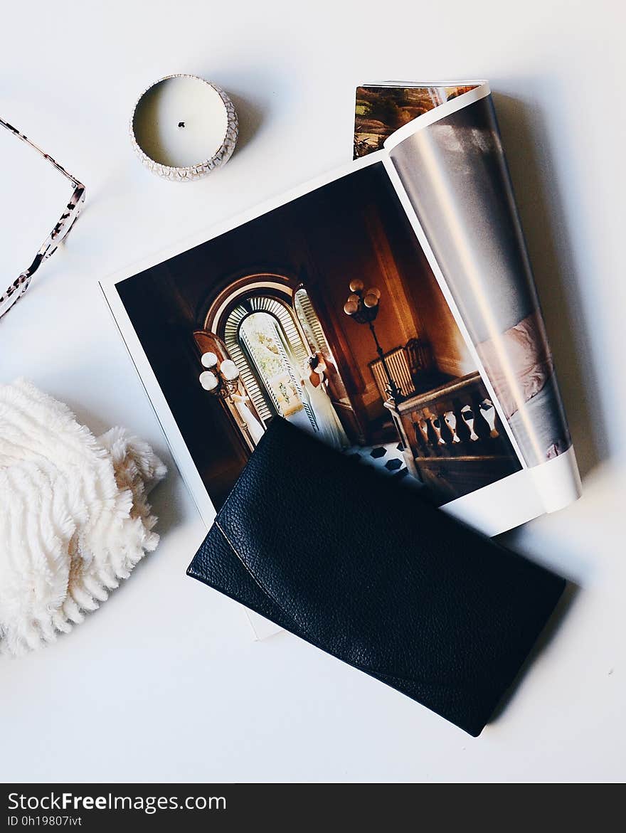 A still life with a purse, print magazine and accessories. A still life with a purse, print magazine and accessories.