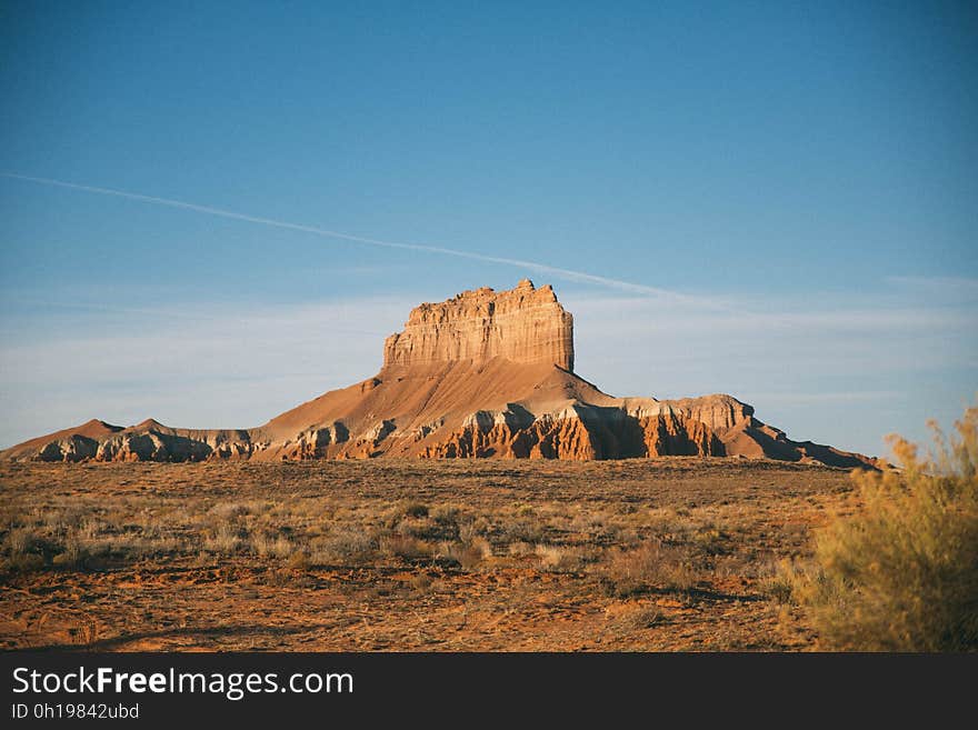 A butte mountain in a desert. A butte mountain in a desert.