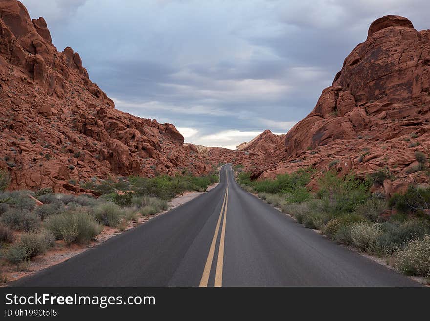 A highway passing through red sandstone cliffs. A highway passing through red sandstone cliffs.