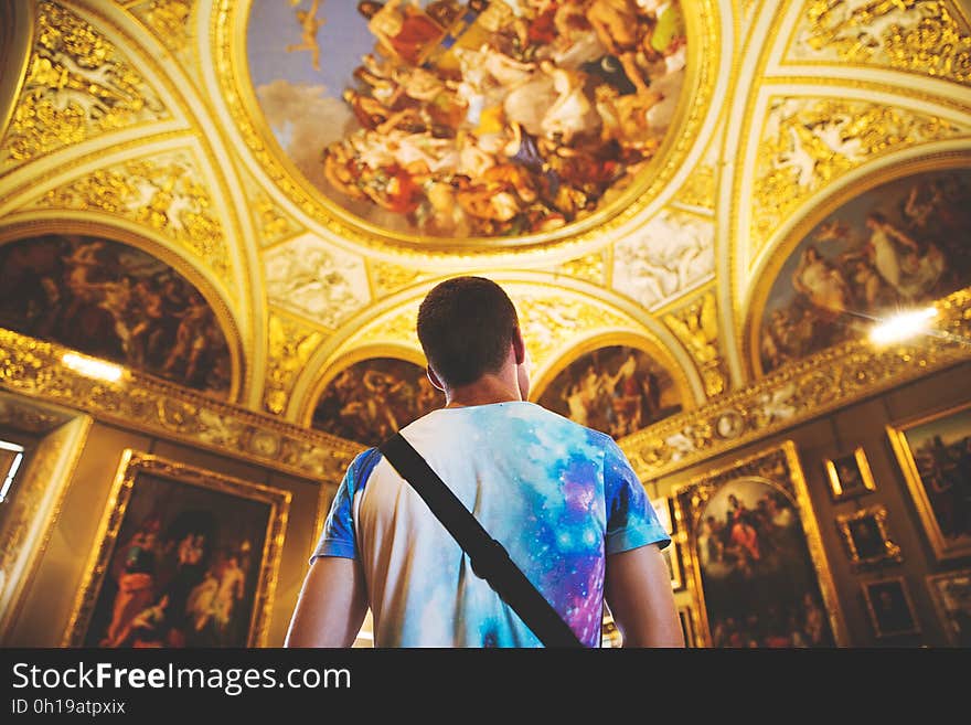 Back of man standing in ornate gild cathedral interior. Back of man standing in ornate gild cathedral interior.