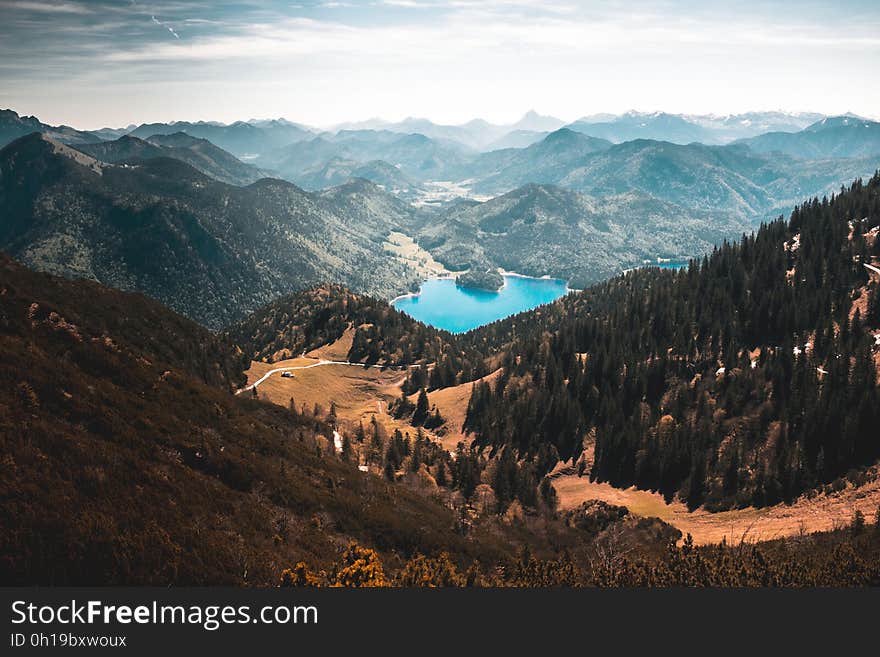 A panoramic view of a turquoise mountain lake in a valley.