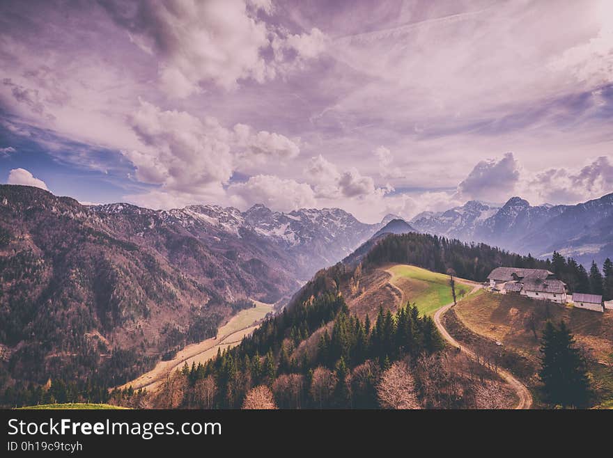 A landscape with mountain range and green valleys. A landscape with mountain range and green valleys.