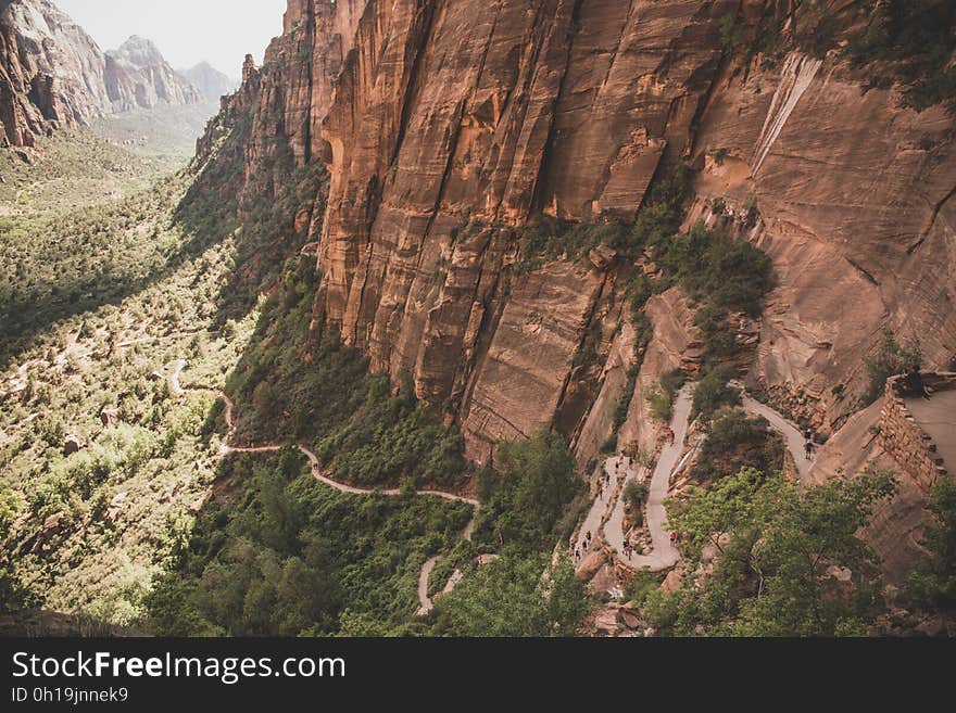 Aerial View Photo of Brown and Green Cliff With Green Plants during Daytime