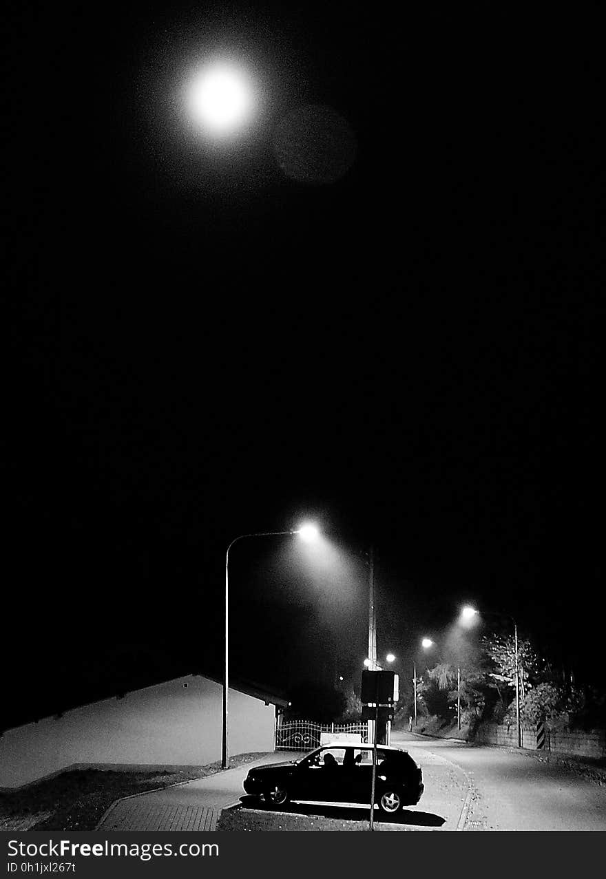 Full Moon Above 5 Door Hatchback Near Electrical Post