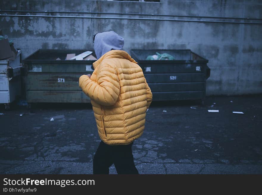 Person in Yellow Puffer Jacket Walking