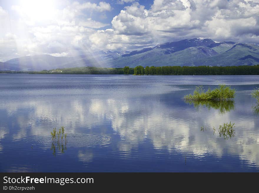 Beautiful Nature Background.Lake,pond,water.Art Photography.Idyllic Summer Landscape,clear mountains.Blue Sky,clouds.Background.