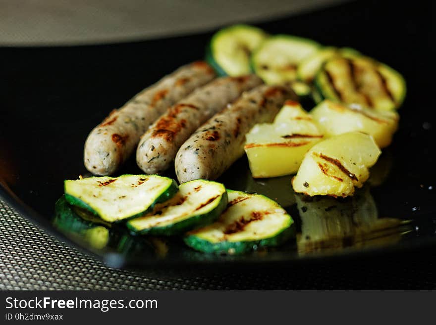 Green Yellow and Brown Food on Black Square Ceramic Plate