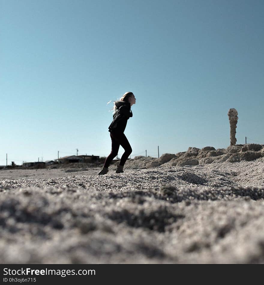 Woman in Black Hoodie and Skinny Jeans in Sandy Field