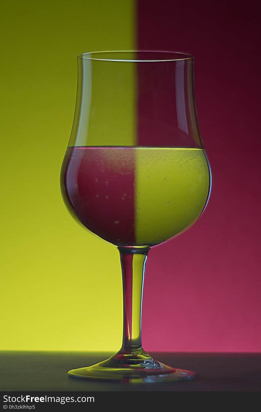 Close-up of Beer Glass Against Colored Background