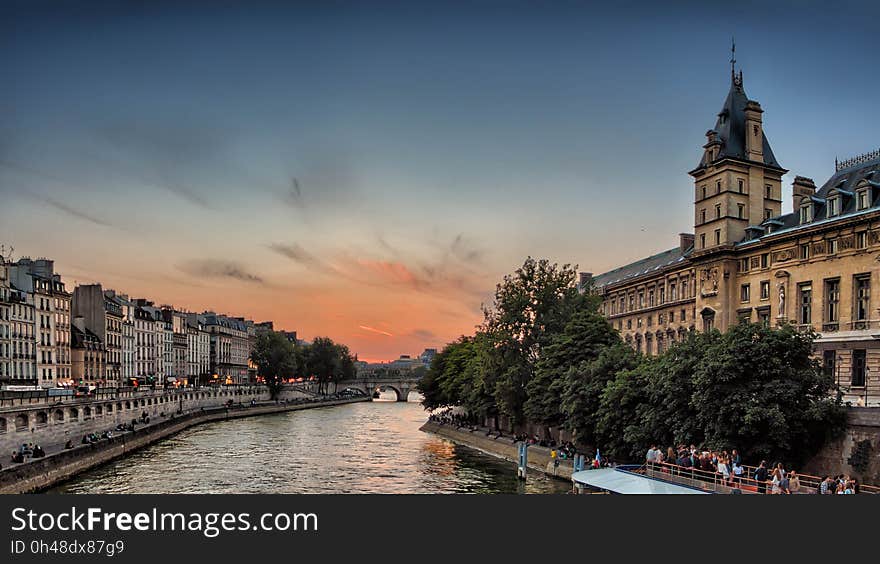 Green Trees Near Yellow Concrete Building Under Cloudy Blue Sky during Sunset