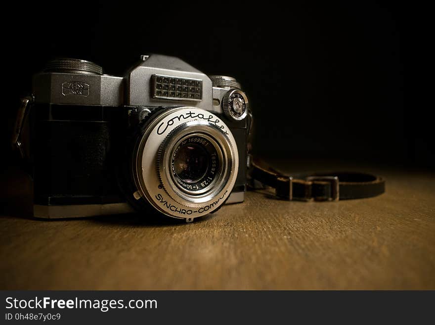 Black and Grey Bridge Camera on Brown Wood Platform