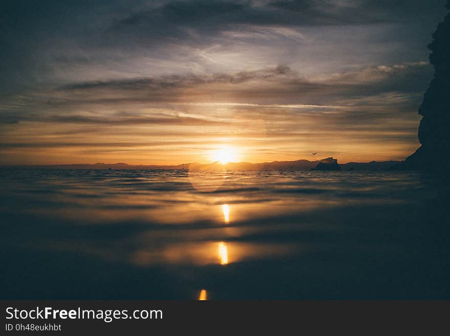 Scenic View of Sea Against Dramatic Sky during Sunset