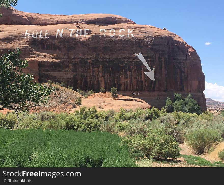 A massive rock with the message hole in the rock and a pointing arrow. A massive rock with the message hole in the rock and a pointing arrow.