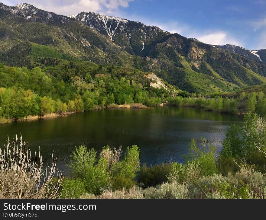 A view of a mountain lake and mountain slopes in the background.