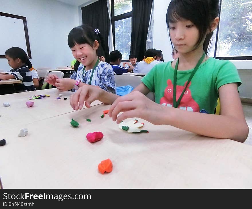 Asian children making paper handicrafts at a workshop. Asian children making paper handicrafts at a workshop.