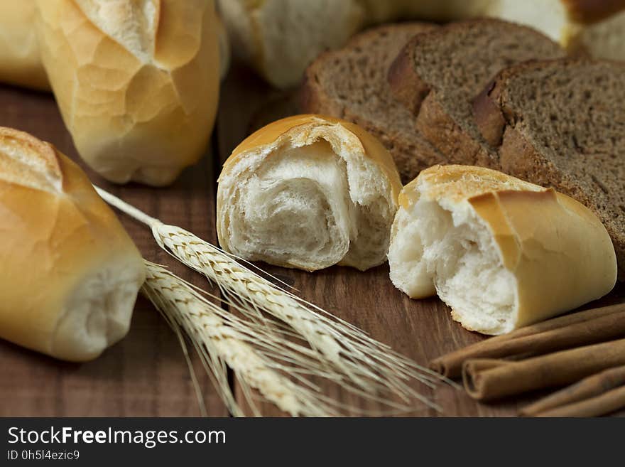 Sliced Bread Beside Wheat on Table