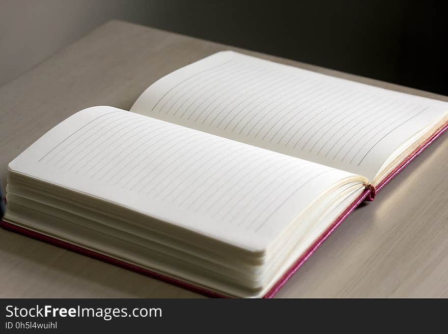 White Lined Notebook on Gray Table