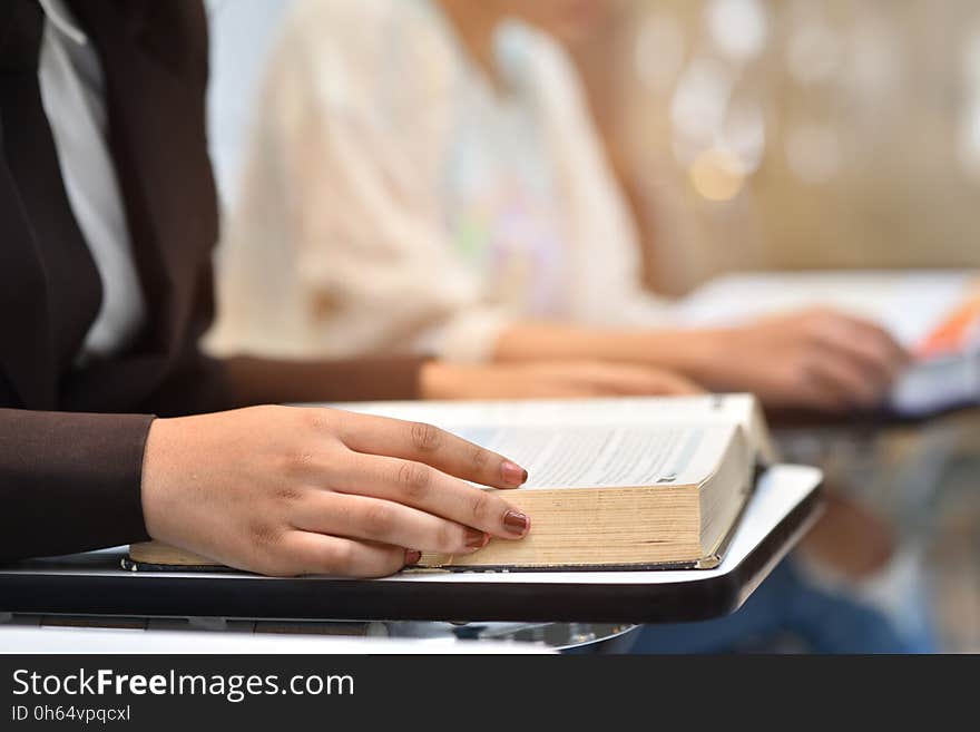 University students read the exam papers in classroom.