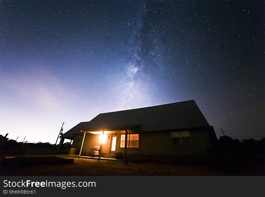 Beige Wooden House Under Starry Night