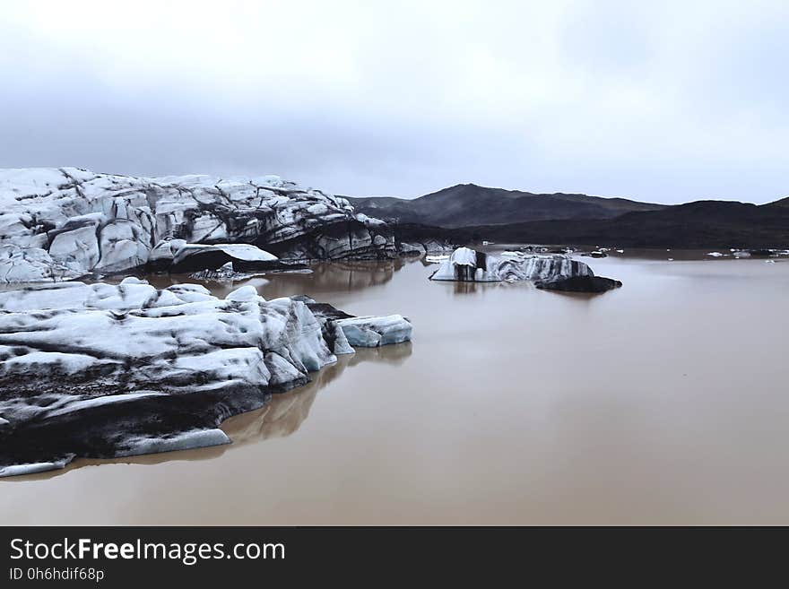 Brown Water Lake and White and Black Stone Formation