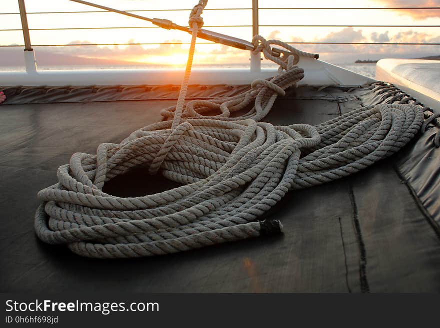 White Tight Rope Near a Brown Surface during Sun Set