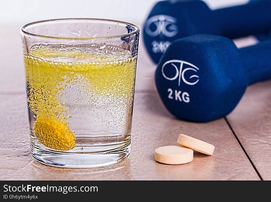 Melting Yellow Tablet in the Filled Drinking Glass