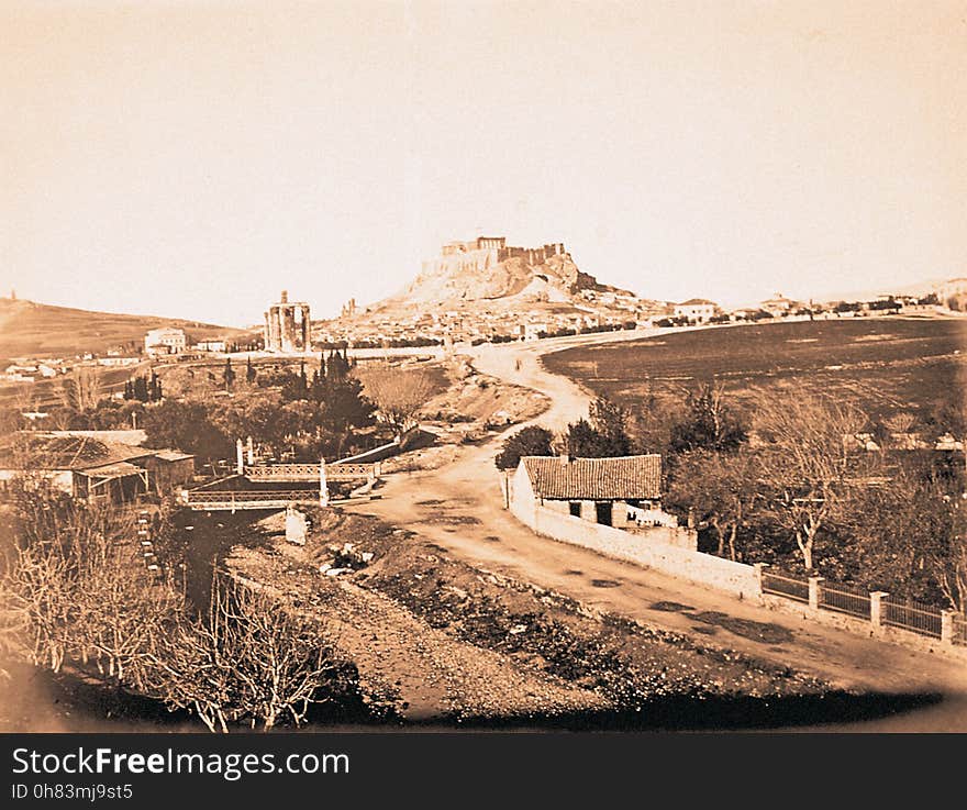 A view along the banks of the Ilissos, with the Protestant Cemetery to the right &#x28;out of view&#x29;. Zappeion has yet to be built. Dated by presence of the hermit&#x27;s dwelling, columns of Jupiter, which was demolished in 1866. A view along the banks of the Ilissos, with the Protestant Cemetery to the right &#x28;out of view&#x29;. Zappeion has yet to be built. Dated by presence of the hermit&#x27;s dwelling, columns of Jupiter, which was demolished in 1866.