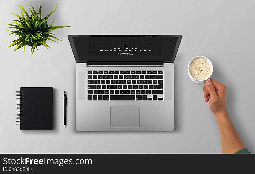 Man Using Laptop on Table Against White Background