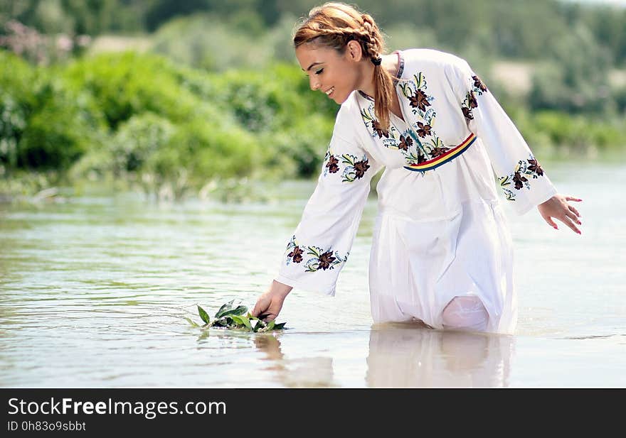 Woman in White Dress in the Water at Daytime