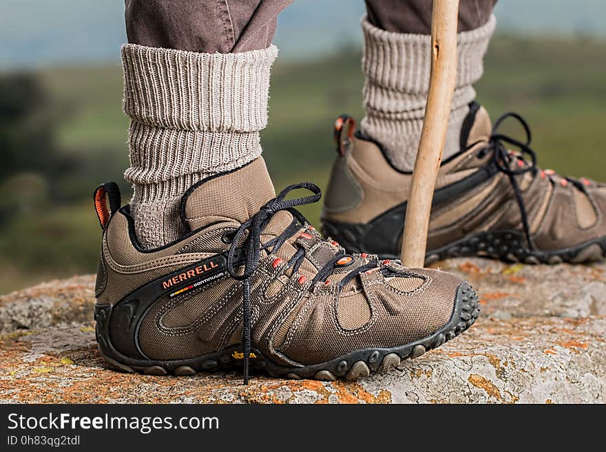 Men&#x27;s Brown and Gray Merrell Hiking Shoes Holding Stick