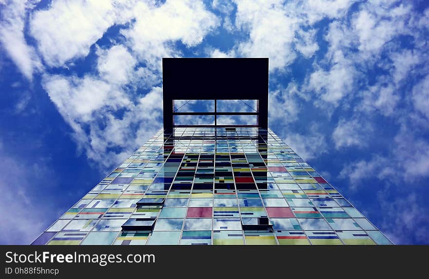 Low Angle Photography of Glass Building Under White Cloud and Blue Sky during Daytime