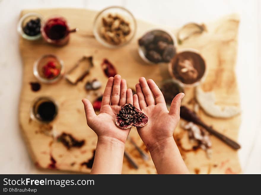 Close up of child hands preparing baking cookies.