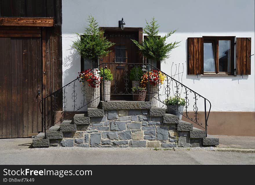 Brown Wooden Door in Front of Bricked Stairs