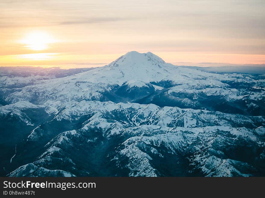 Black Mountain Covered in Snow during Sunset