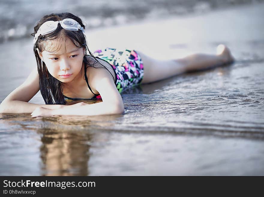 Selective Color Photography of Girl Lying on Beach