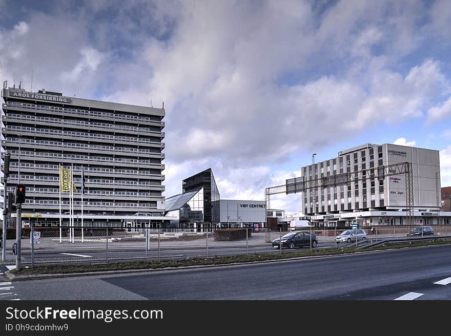 Viby Torv with Hotel Mercur &#x28;left&#x29;, Viby Centret &#x28;mall, the low building&#x29; and the bak- and office building &#x28;right&#x29;. Looking across from Skanderborgvej. From a registrant photowalk series made for the local historical society. The purpose of these walks is not to take photos of individual buildings, but rather to document the streets as a whole in order to preserve the views for future generations. Some houses will inevitably be obscured behind fences and hedges. In such cases, there will be a photo of the hedge or fence in question. The photo will, of course, be rubbish, but it will accurately show the best possible view from a public road. Over the years, fences and hedges will come and go &#x28;as will the houses&#x29;, sometimes improving the views, other times, the opposite. I&#x27;ve made every attempt to blur visible names, faces and license plates, in order to respect people&#x27;s privacy. Viby Torv with Hotel Mercur &#x28;left&#x29;, Viby Centret &#x28;mall, the low building&#x29; and the bak- and office building &#x28;right&#x29;. Looking across from Skanderborgvej. From a registrant photowalk series made for the local historical society. The purpose of these walks is not to take photos of individual buildings, but rather to document the streets as a whole in order to preserve the views for future generations. Some houses will inevitably be obscured behind fences and hedges. In such cases, there will be a photo of the hedge or fence in question. The photo will, of course, be rubbish, but it will accurately show the best possible view from a public road. Over the years, fences and hedges will come and go &#x28;as will the houses&#x29;, sometimes improving the views, other times, the opposite. I&#x27;ve made every attempt to blur visible names, faces and license plates, in order to respect people&#x27;s privacy.