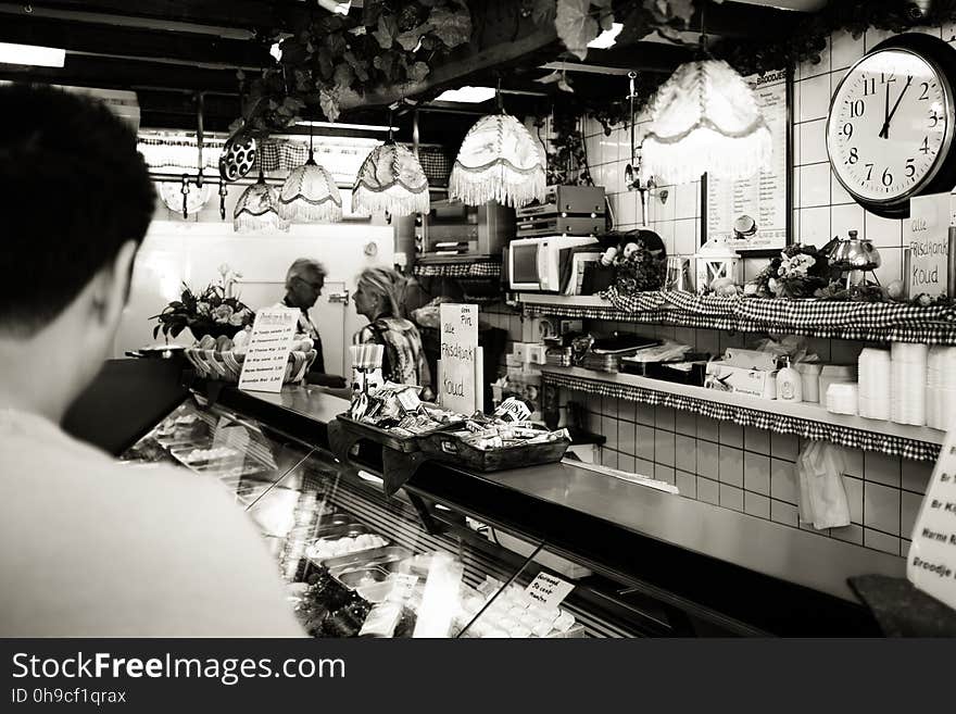 Man Wearing White Shirt in a Cafe in Gray Scale Photography