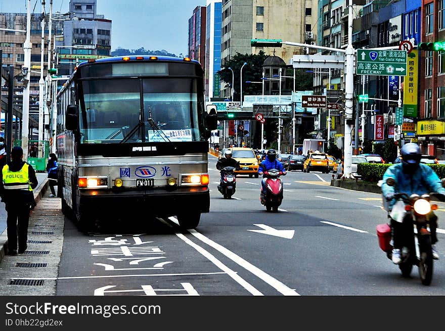 Busy street in Asia with bus and motorcycles.