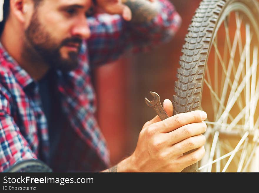 Man repairing bike with wrench