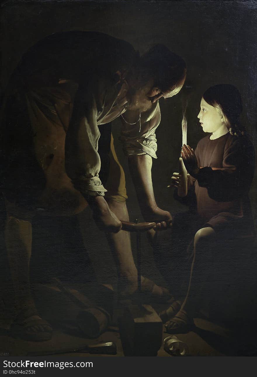 An old man with a child holding a light. An old man with a child holding a light.