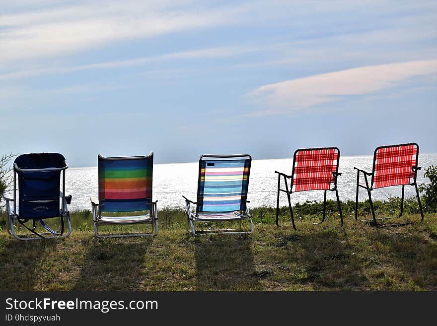 Beach Chairs lined up on the side of the bay