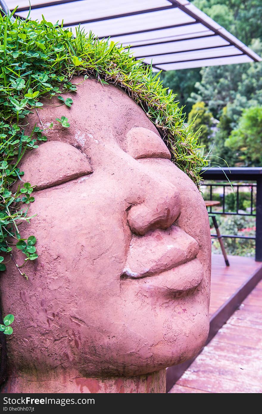 Ceramic doll with grass on head, Thailand.