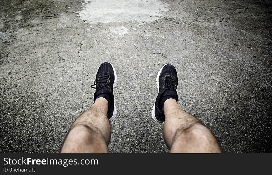 Legs of a man resting in the city, detail of a moment of relax and rest